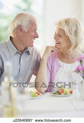 Stock Photo - Couple enjoying healthy meal in restaurant. Fotosearch