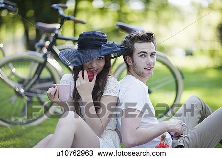 Couple having picnic in park View Large Photo Image Stock Image - Couple having picnic in park. Fotosearch