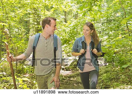 Couple hiking in forest View Large Photo Image Stock Photo - Couple hiking in forest. Fotosearch