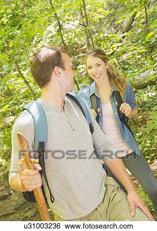 Stock Photograph - Couple hiking in forest. Fotosearch