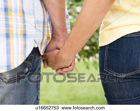Stock Image - Couple holding hands. Fotosearch