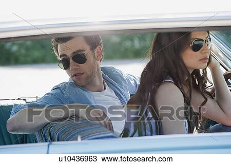 Couple in vintage car View Large Photo Image Stock Image - Couple in vintage car. Fotosearch