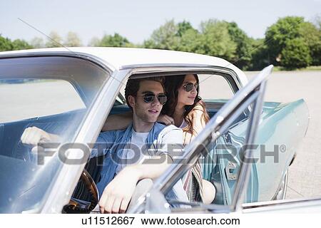 Couple in vintage car View Large Photo Image Stock Photo - Couple in vintage car. Fotosearch