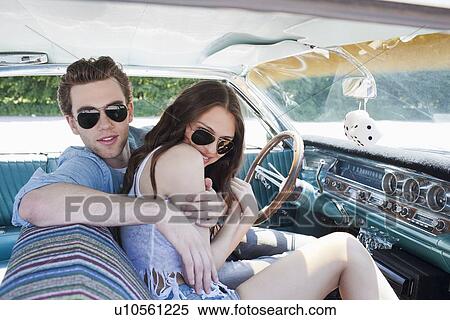Stock Photography - Couple in vintage car. Fotosearch