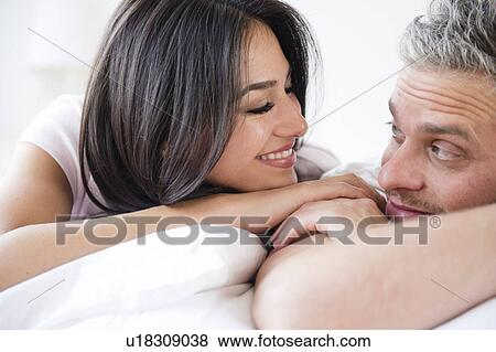 Couple lying together View Large Photo Image Stock Photo - Couple lying together . Fotosearch
