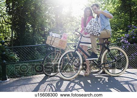 Couple on bikes View Large Photo Image Stock Image - Couple on bikes. Fotosearch