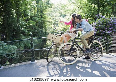 Couple on bikes View Large Photo Image Stock Photo - Couple on bikes. Fotosearch
