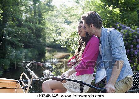 Couple on bikes View Large Photo Image Stock Photography - Couple on bikes. Fotosearch