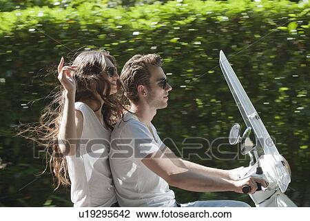 Couple on scooter View Large Photo Image Stock Image - Couple on scooter. Fotosearch
