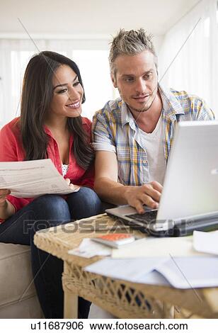 Stock Photograph - Couple paying bills. Fotosearch