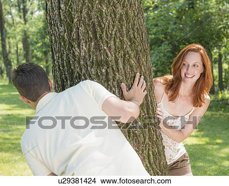 Picture - Couple playing in forest. Fotosearch