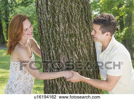 Stock Image - Couple playing in forest. Fotosearch