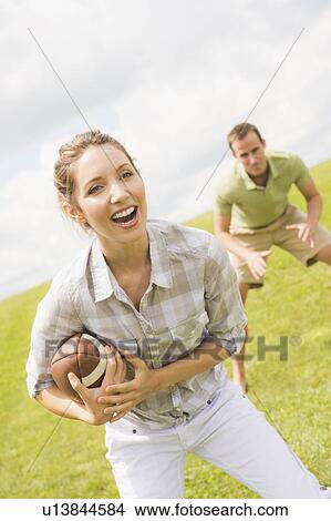 Picture - Couple playing with football. Fotosearch