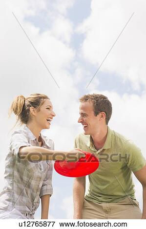 Stock Photo - Couple playing with frisbee. Fotosearch