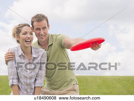 Stock Photo - Couple playing with frisbee. Fotosearch