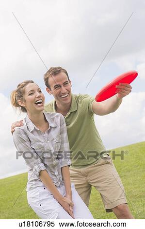 Couple playing with frisbee View Large Photo Image Stock Photography - Couple playing with frisbee. Fotosearch