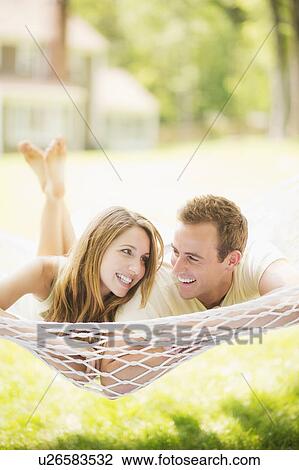 Couple relaxing in hammock View Large Photo Image Stock Image - Couple relaxing in hammock. Fotosearch
