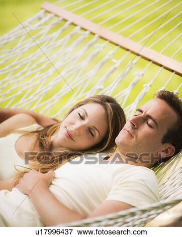 Stock Photo - Couple relaxing in hammock. Fotosearch