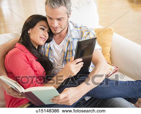 Couple relaxing on sofa View Large Photo Image Stock Photograph - Couple relaxing on sofa. Fotosearch