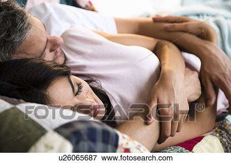 Stock Photo - Couple sleeping together. Fotosearch
