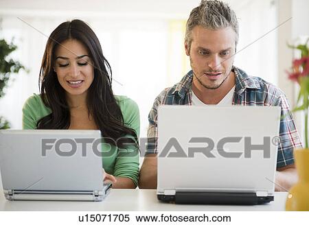 Couple using laptops View Large Photo Image Stock Photography - Couple using laptops. Fotosearch