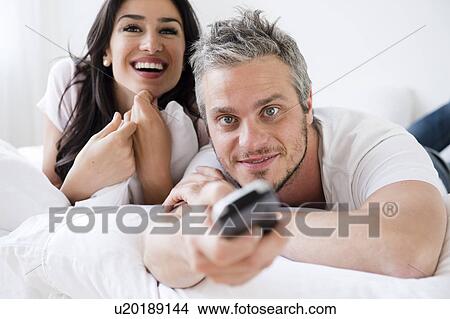 Picture - Couple watching television. Fotosearch