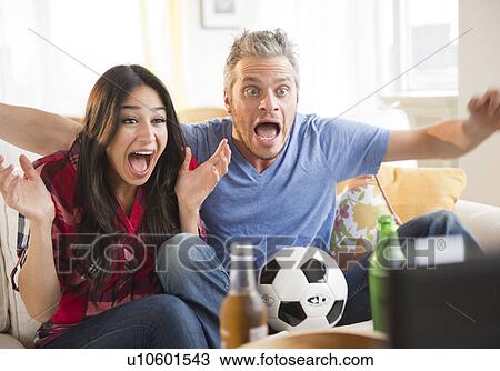 Stock Image - Couple watching tv. Fotosearch