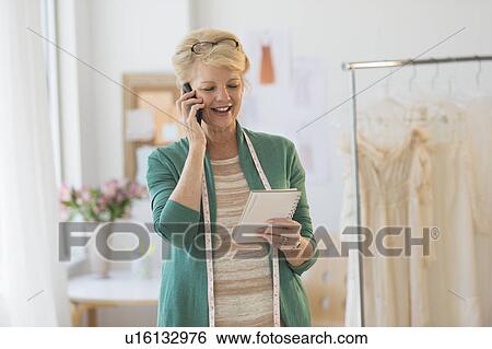 Stock Photograph - Fashion designer in studio. Fotosearch