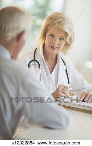 Picture - Female and male doctors talking. Fotosearch