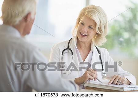 Stock Photo - Female and male doctors talking. Fotosearch