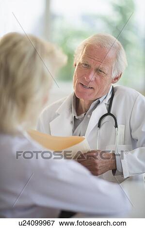 Female and male doctors talking View Large Photo Image Stock Photo - Female and male doctors talking. Fotosearch