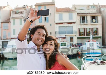 France, Cassis, Couple taking picture with smartphone View Large Photo Image Stock Image - France, Cassis, Couple taking picture with smartphone. Fotosearch