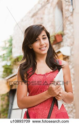 Stock Photo - France, Cassis, Young woman holding digital tablet. Fotosearch