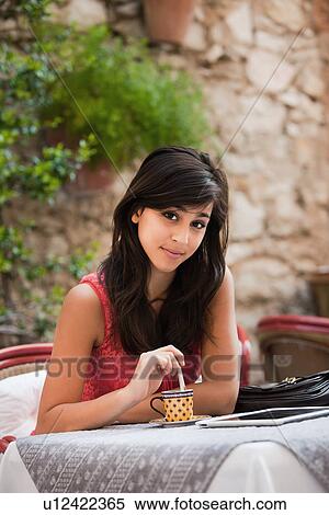 France, Cassis, Young woman in cafe stirring coffee View Large Photo Image Stock Photography - France, Cassis, Young woman in cafe stirring coffee. Fotosearch