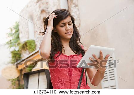 France, Cassis, Young woman using digital tablet on street View Large Photo Image Stock Image - France, Cassis, Young woman using digital tablet on street. Fotosearch