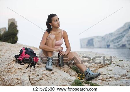 France, Marseille, Female hiker resting on rocky beach View Large Photo Image Stock Image - France, Marseille, Female hiker resting on rocky beach. Fotosearch
