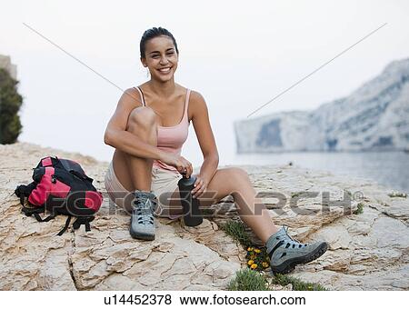 France, Marseille, Female hiker resting on rocky beach View Large Photo Image Stock Photo - France, Marseille, Female hiker resting on rocky beach. Fotosearch