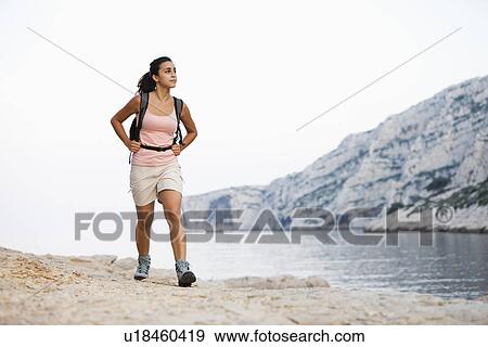 Stock Photo - France, Marseille, Woman hiking on seaside. Fotosearch