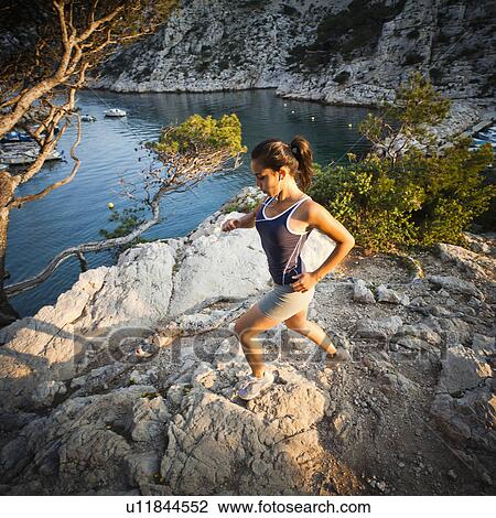 France, Marseille, Young woman jogging in rocky terrain View Large Photo Image Stock Image - France, Marseille, Young woman jogging in rocky terrain. Fotosearch