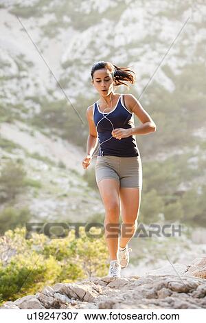 France, Marseille, Young woman jogging on rocky terrain View Large Photo Image Stock Photo - France, Marseille, Young woman jogging on rocky terrain. Fotosearch
