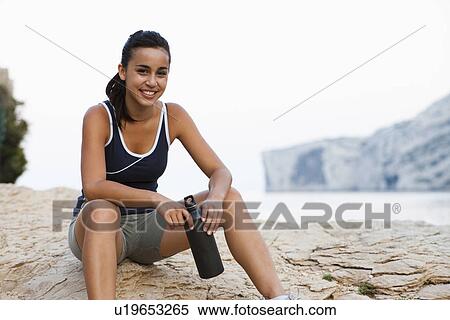 Stock Photography - France, Marseille, Young woman resting after run. Fotosearch