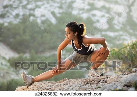 France, Marseille, Young woman stretching on cliff View Large Photo Image Stock Image - France, Marseille, Young woman stretching on cliff. Fotosearch