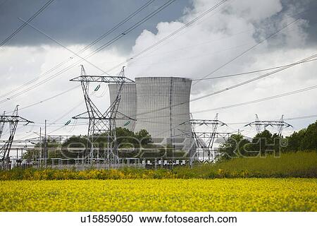 Stock Image - France, Rocroi, Rural landscape with power line and power station. Fotosearch