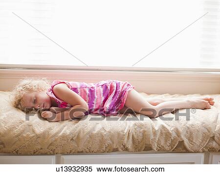 Girl (4-5) sleeping on bed View Large Photo Image Stock Photography - Girl (4-5) sleeping on bed. Fotosearch