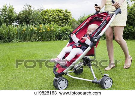 Girl in pram crying during walk View Large Photo Image Stock Image - Girl in pram crying during walk. Fotosearch