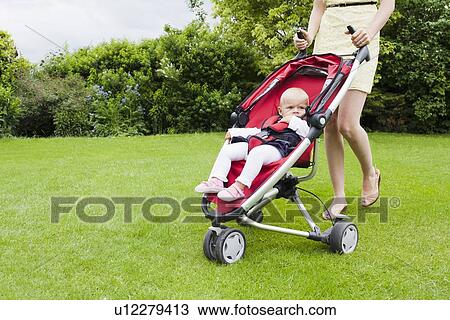 Stock Image - Girl in pram during walk. Fotosearch