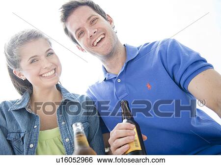 Happy young couple drinking beer View Large Photo Image Stock Photograph - Happy young couple drinking beer. Fotosearch