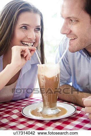 Happy young couple drinking milk shake View Large Photo Image Stock Image - Happy young couple drinking milk shake . Fotosearch