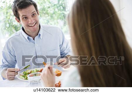Happy young couple eating together View Large Photo Image Stock Image - Happy young couple eating together. Fotosearch