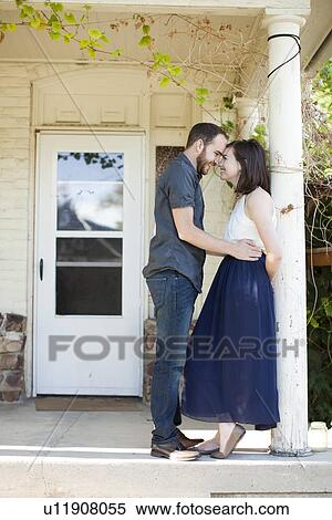Happy young couple in front of house View Large Photo Image Stock Photography - Happy young couple in front of house. Fotosearch